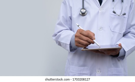 Male Doctor Using Electronic Pen On  Digital Tablet, Reviewing  Medical Record Writing Prescription On Digital Document, Electronic Medical Record System, Health And Technology, Telemedicine Concept