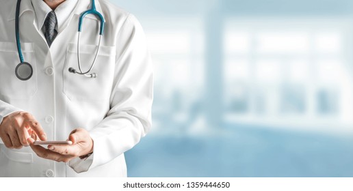 Male doctor using mobile phone at hospital. Medical healthcare and doctor service. - Powered by Shutterstock