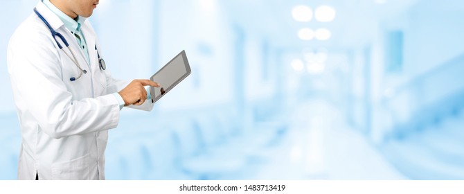 Male doctor using tablet computer at hospital. Medical research staff and doctor service. - Shutterstock ID 1483713419