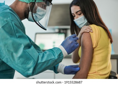 Male doctor vaccine a young woman patient - Vaccination against coronavirus pandemic