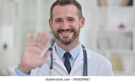 Male Doctor Waving Hand For Video Call 