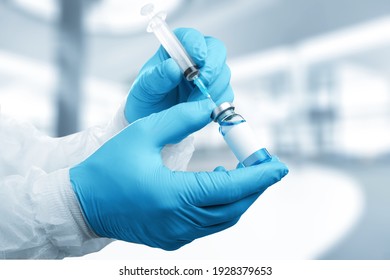 Male Doctor Wearing Medical Gloves Holding Covid 19 Coronavirus Vaccine From Vial Bottle