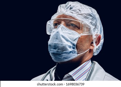 Male doctor wearing protective Mask and Goggles. Dark background. Close up