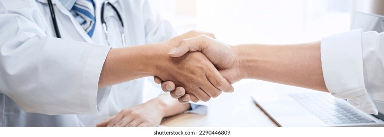 Male doctor in white coat shaking hands with the patient after successful treatment and recommend method recuperate. - Powered by Shutterstock