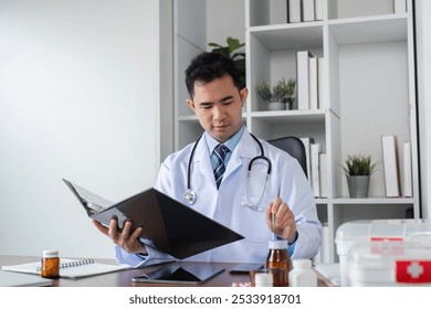 Male Doctor in White Coat Studying Medical Textbook for Healthcare Research in Modern Office Setting with Medical Equipment - Powered by Shutterstock