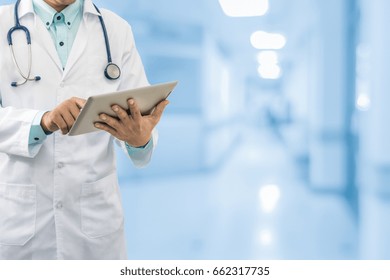 Male Doctor Working On Computer Tablet In The Hospital Or Healthcaring Center. Concept Of Medical Data Analysis For Healthcare Business.