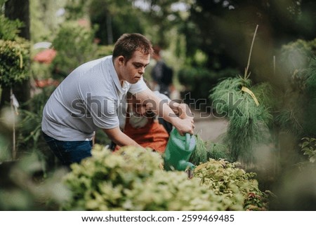 A male with Down syndrome and a female in a wheelchair engage in gardening, promoting inclusion and teamwork in a lush garden setting.