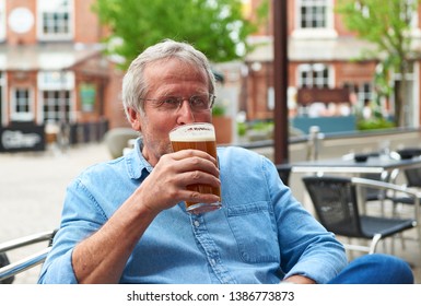 Male Drinking Beer Outside A Bar 