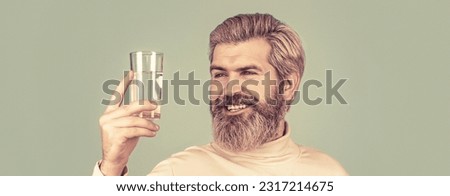 Male drinking from a glass of water. Health care concept, lifestyle, close up. Smiling male holding transparent glass in her hand.