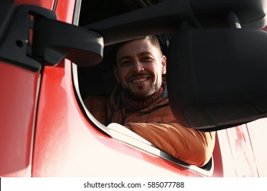 Male Driver Looking Out Of Truck Window