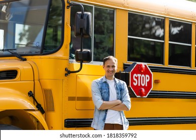 Male driver standing in front of bus