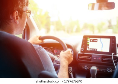 a male driver travels by car at the wheel with a Navigator. flare