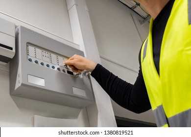 Male Electrician Opening Fire Panel In Server Room - Shutterstock ID 1380819521