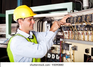 Male Electrician Repairing Industrial Machine Control Component