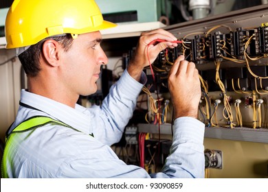 male electrician testing industrial machine - Powered by Shutterstock