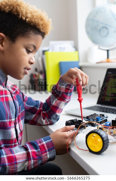 Male Elementary School Pupil Building Robot Car In\
Science Lesson
