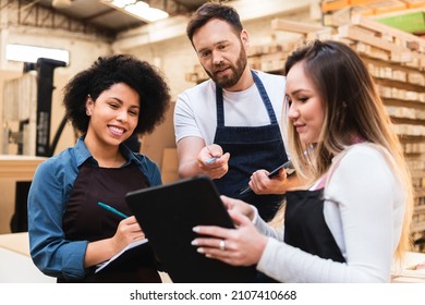 Male Employee Collaborating Thoughts And Ideas With The Team At Warehouse