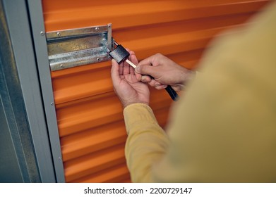 Male Employee Locking The Storage Unit Door