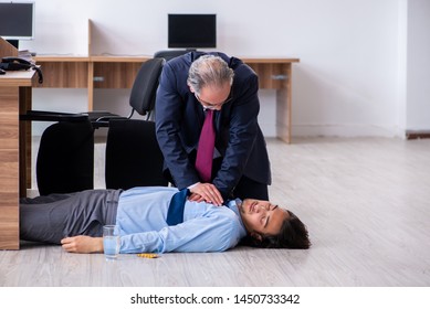 Male employee suffering from heart attack in the office 