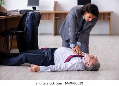 Male employee suffering from heart attack in the office 