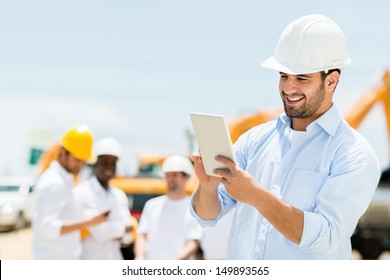 Male Engineer At A Construction Site With A Tablet Computer 