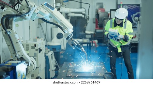 Male engineer controller operation robot arm testing system program welding with remote control.