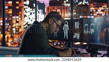 Male Engineer Developer of Space Suits and Space Gear Work in His Home Studio. Caucasian Latino Man Creating 3D Virtual Models of Spacesuits and Makes Corrections to Paper Sketches. . High quality