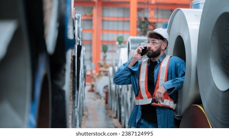 Male engineer or factory worker talking on smartphone - Powered by Shutterstock