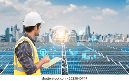 Male engineer in hard hat and safety vest using a tablet to monitor solar panels with digital energy data overlay. - Powered by Shutterstock - Get 15% off with code: PIKWIZARD15