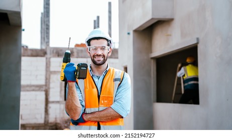 Male Engineer Smile Holding Cordless Drill On Site Under Construction.Middle Eastern, Caucasian,European Men Wear PPE,hard Hats,reflective Vests, Gloves,safety Glasses,safety First Concept.Ready Work.