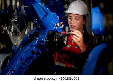 male engineer workers maintenance automatic robotic arm machine in a factory. worker checking and repairing automatic robot hand machine. technician worker check for repair factory machine.