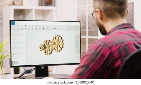 Male Engineer Working On A 3d Design From Home. Girlfriend In The Background.