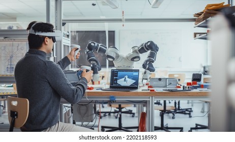 Male Engineering Student Wearing AR Headset, Designs and Manipulates Robot Hand by Using Controllers. Futuristic Virtual Reality Design and Mixed Technology Professional Application Concept. - Powered by Shutterstock