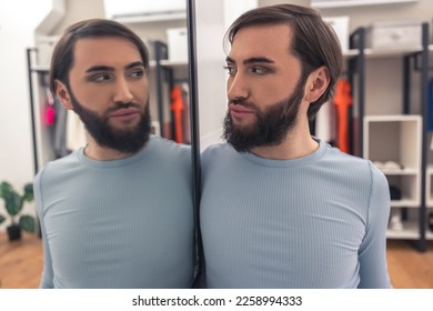 Male examining his mirror reflection after the makeup application - Powered by Shutterstock