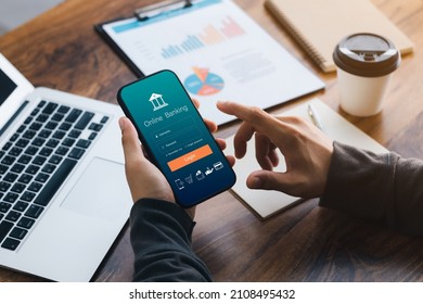 Male executive using smartphone to conduct online mobile banking, investing in stocks and mutual funds, retirement investment ideas. - Shutterstock ID 2108495432