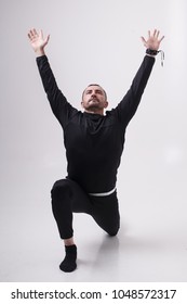 Male Exercisers On The Cyclorama. Makes Techniques From Yoga, Pilates, Qigong, Callanetics Hiit, In The Shape Of A Triangle, War,