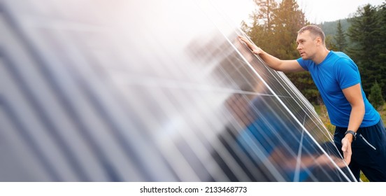 Male Farmer Independently Installs And Connects Electrical Panels On Suburban Area In Mountain For Selfcontained Hermit Housing.