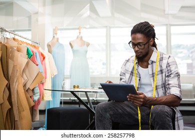 Male fashion designer using digital tablet