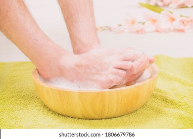 Male Feet In A Bowl With Water And Soap, Hygiene And Spa Concept