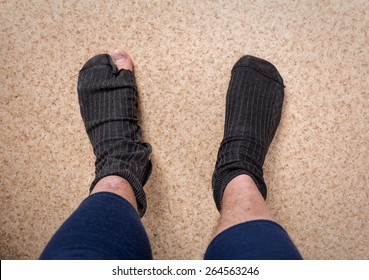 Male Feet In Old Leaky Socks