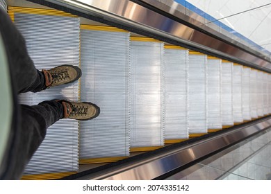 Male Feet On The Escalator, Top View.