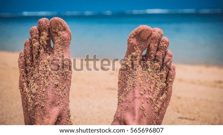 Male Feet at the Sandy Beach, Ocean in Background, Bali, Indonesia
