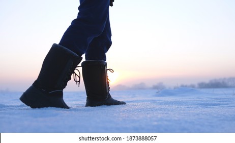 Male Feet Walking In Deep Snow. Foot Steps Of Hiker. Recreational Winter Activity