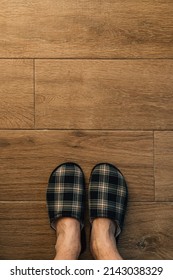 Male Feet Wearing Plaid Slippers In Bathroom, Top View With Copy Space