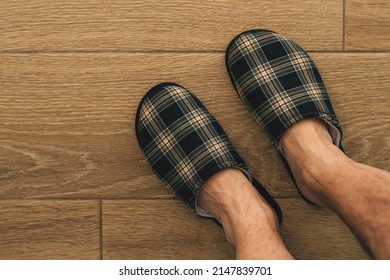 Male Feet Wearing Plaid Slippers In Bathroom, Top View With Copy Space