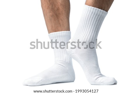Male feet with white cotton socks isolated on white background