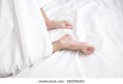 Male Feets On Bed In Morning.