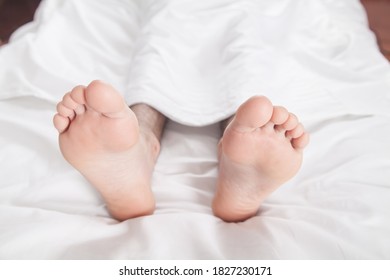 Male Feets On Bed In Morning.