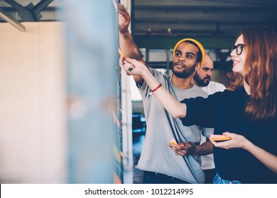 Male and female architects colleagues discussing ideas while collaborating on project sharing creative solution standing near  space area for advertising.Young crew having brainstorming session - Shutterstock ID 1012214995