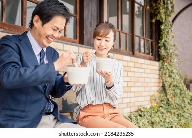 Male And Female Asian Office Workers Who Eat Takeout Curry